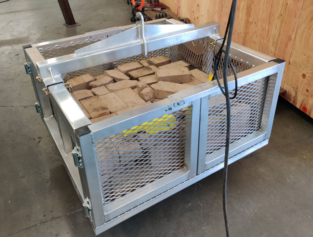 Material transfer basket with load of kiln refractory bricks